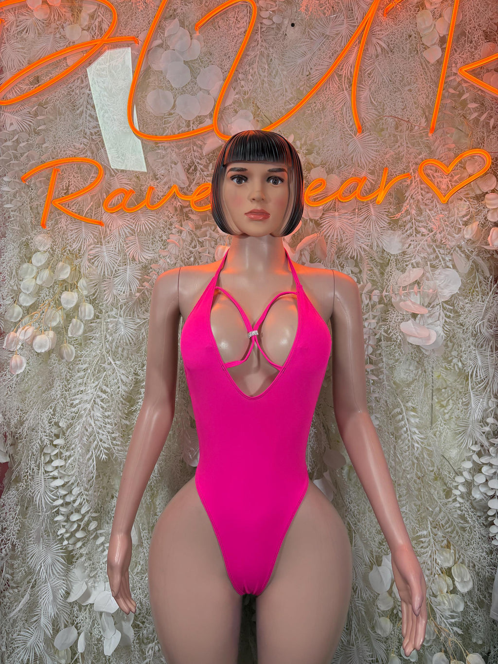 Hot pink halter bodysuit with chest cutout and thong-style bottom.