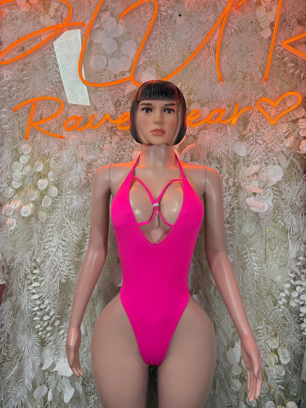 Hot pink cutout bodysuit with halter straps and chest ring detail