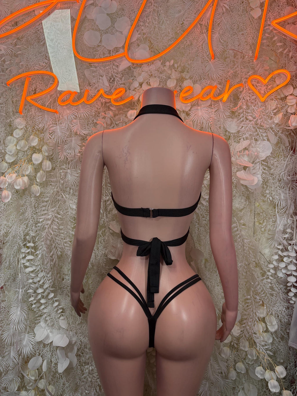 Black strappy back bodysuit with open back and bow tie at lower back