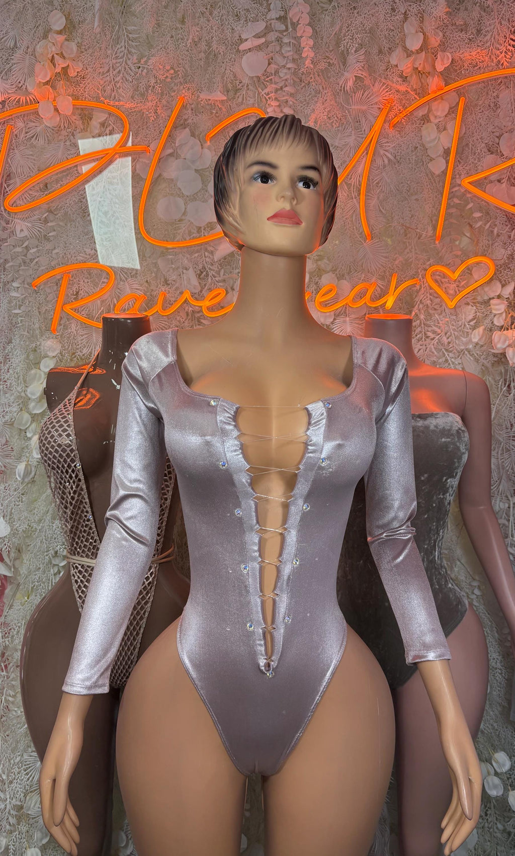 Gray metallic long-sleeve one-piece bodysuit with ruffle-trimmed V neckline and buttons