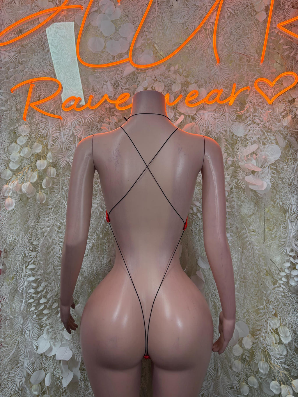 Black fishnet bodysuit back view with crisscross straps and high-cut legs