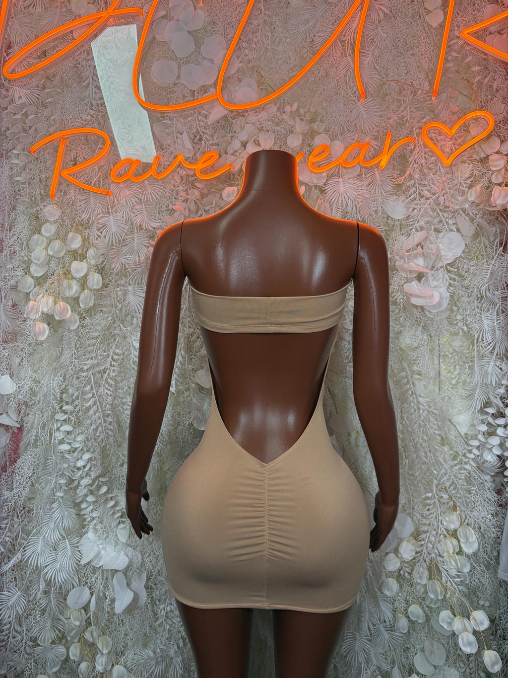 Nude backless mini dress with draped fabric panel at the back