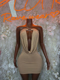 Nude one-piece mini dress with cowl neckline and ruched side seams