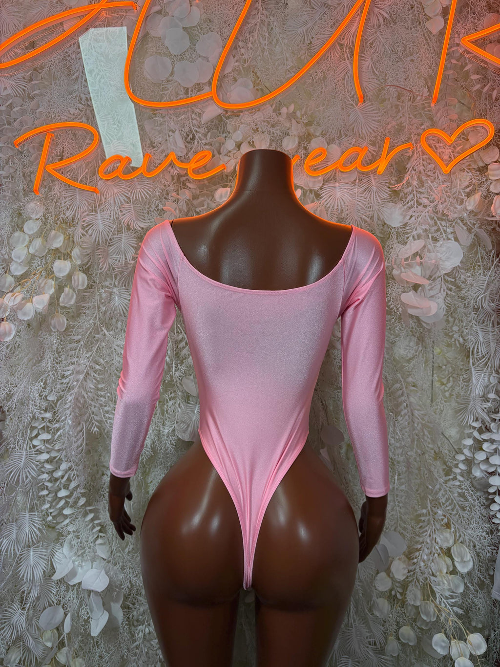 Pink long-sleeve bodysuit with wide U-shaped open back and smooth front