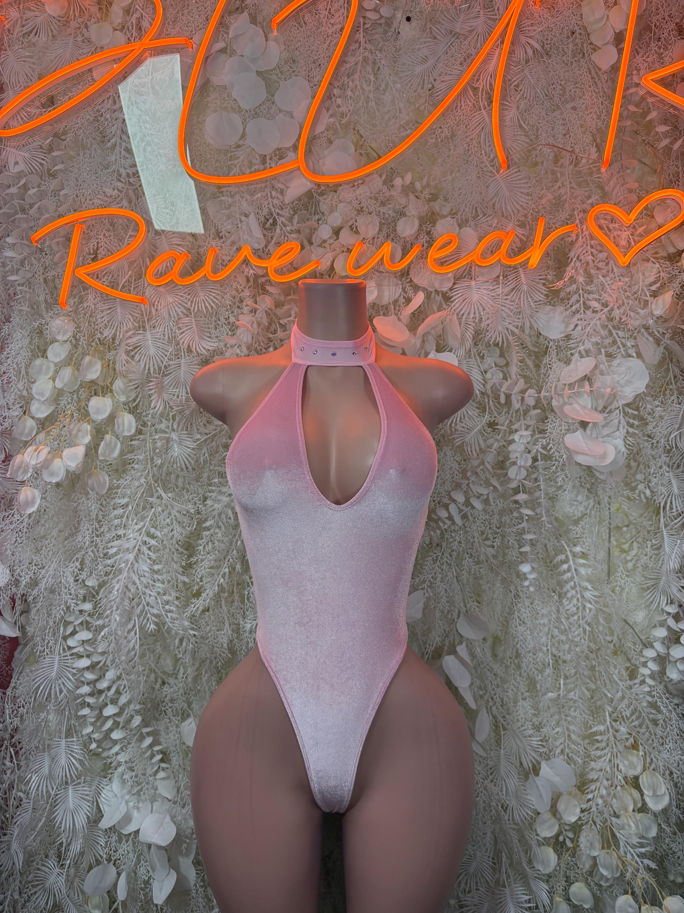 Pink velvet bodysuit with halter neckline, keyhole chest, and high-cut legs