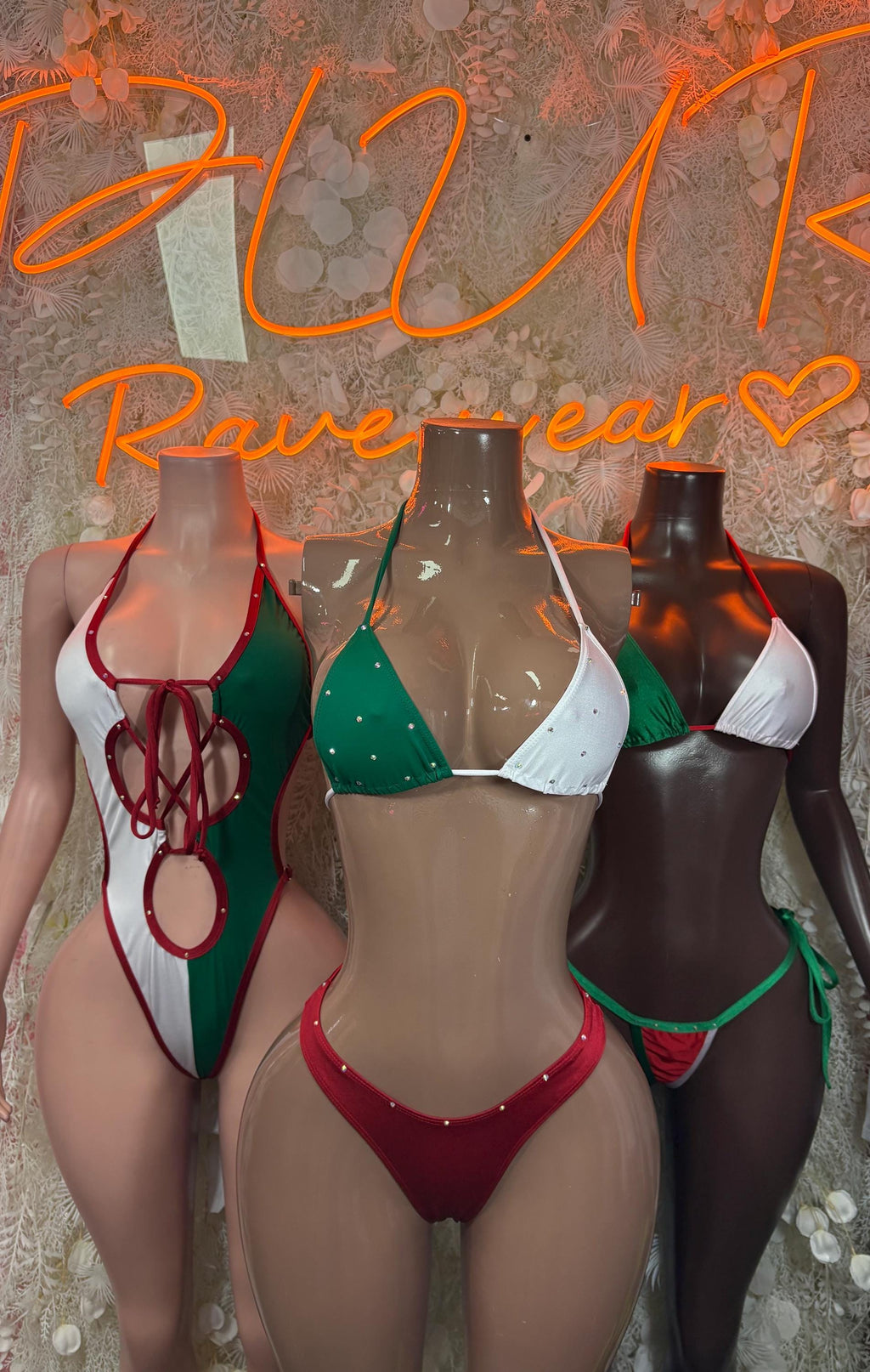 Bikini set displayed on three mannequins in red, green, and white