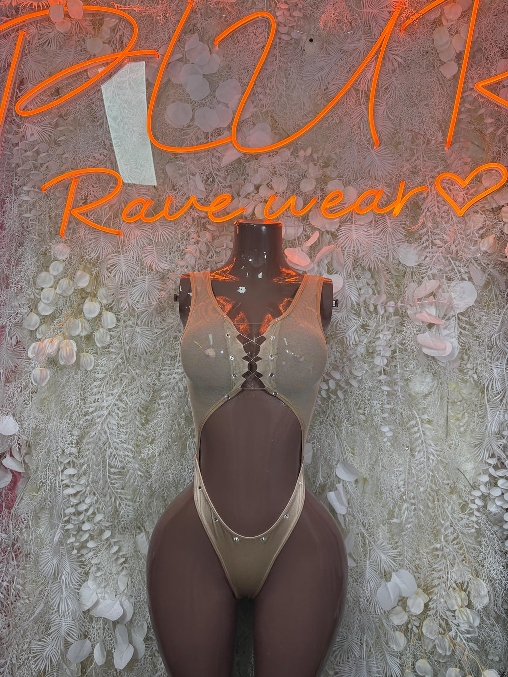 Tan lace bodysuit with deep V neckline and central chest cutout