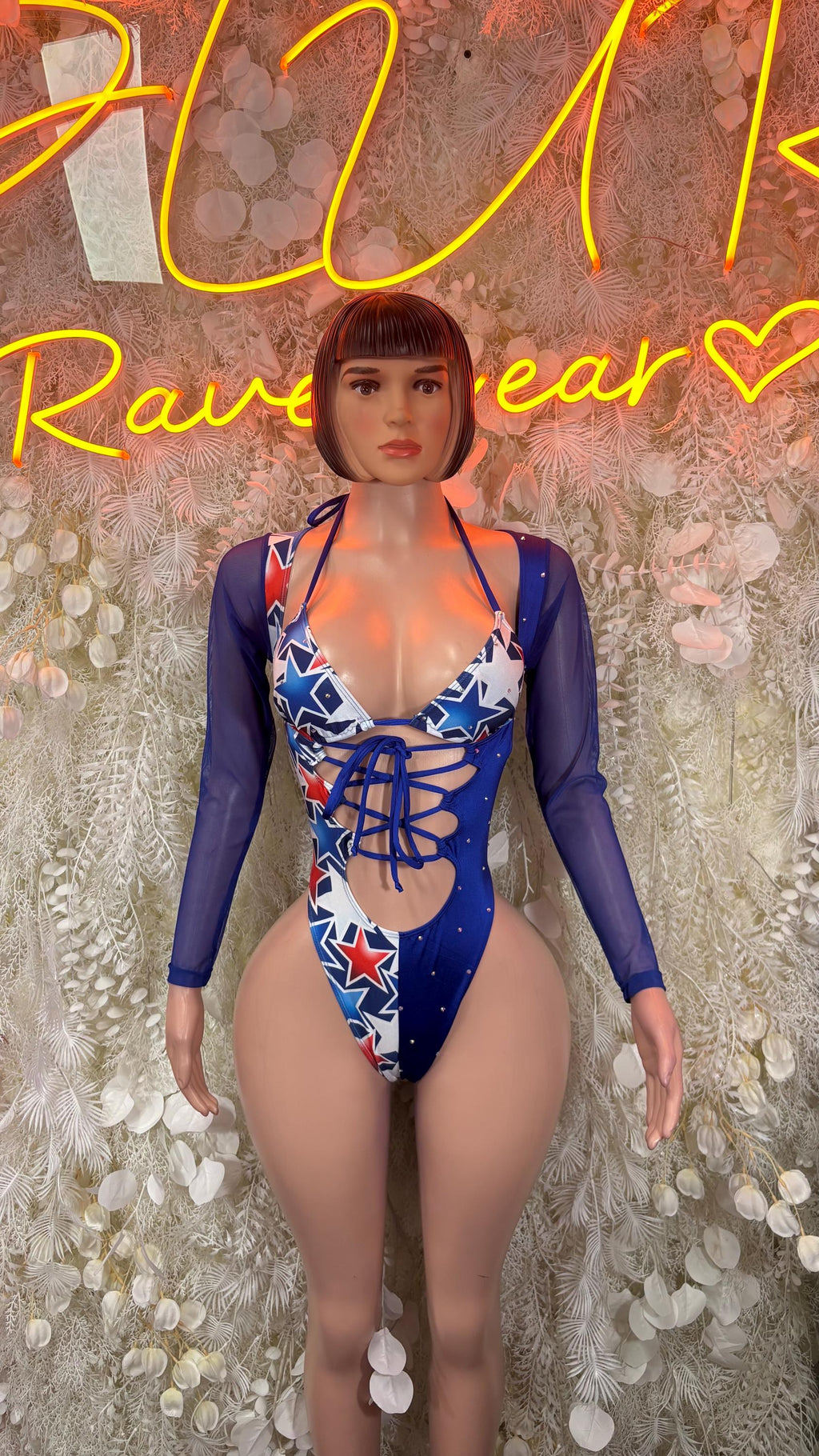 Blue star print bodysuit with crisscross lace-up front and sheer long sleeves, front view