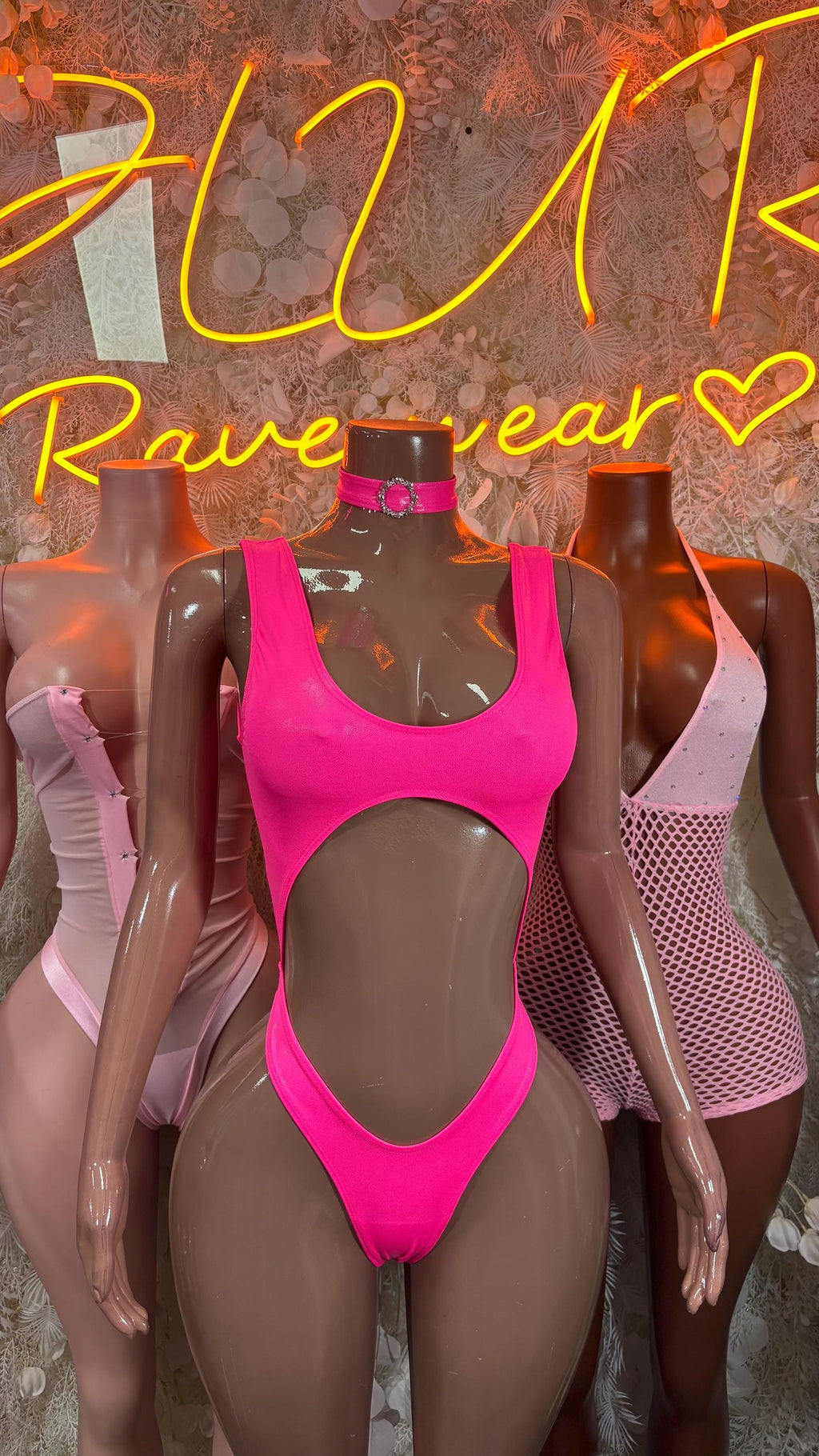 Pink halter rave bodysuit with central cutout and high-leg thong style
