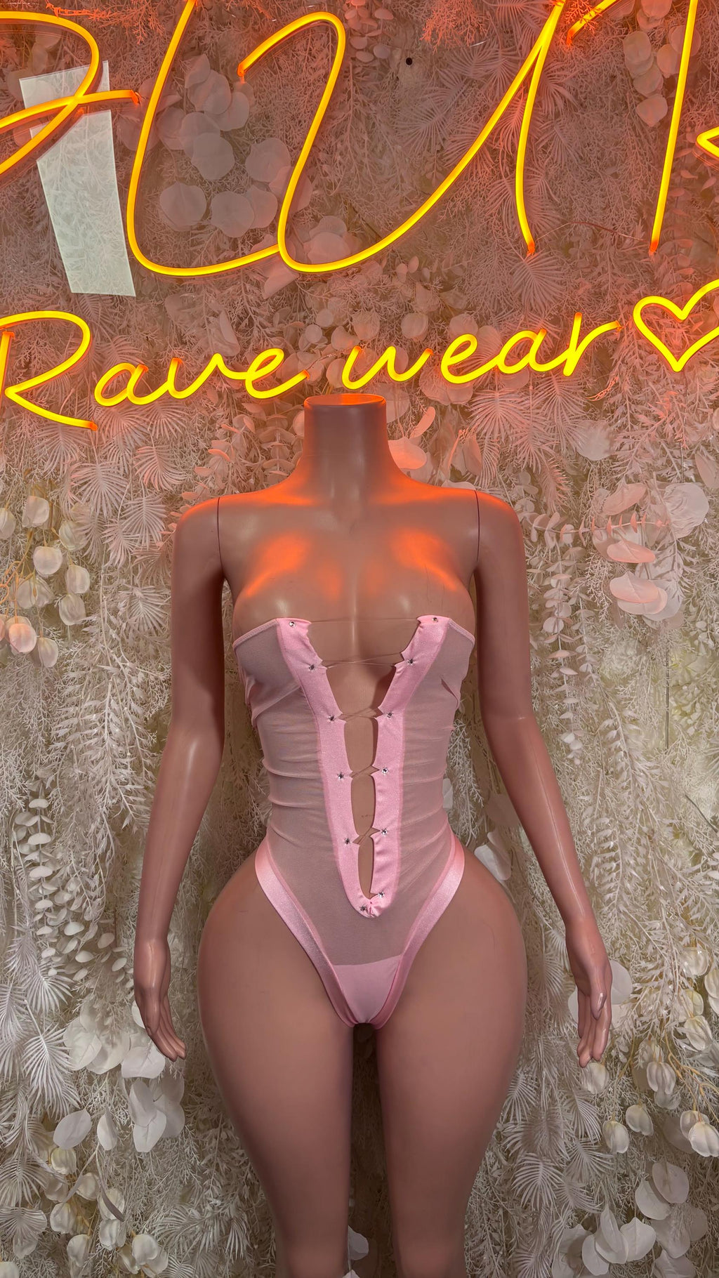 Pink baby bodysuit with lace-up front and sweetheart neckline
