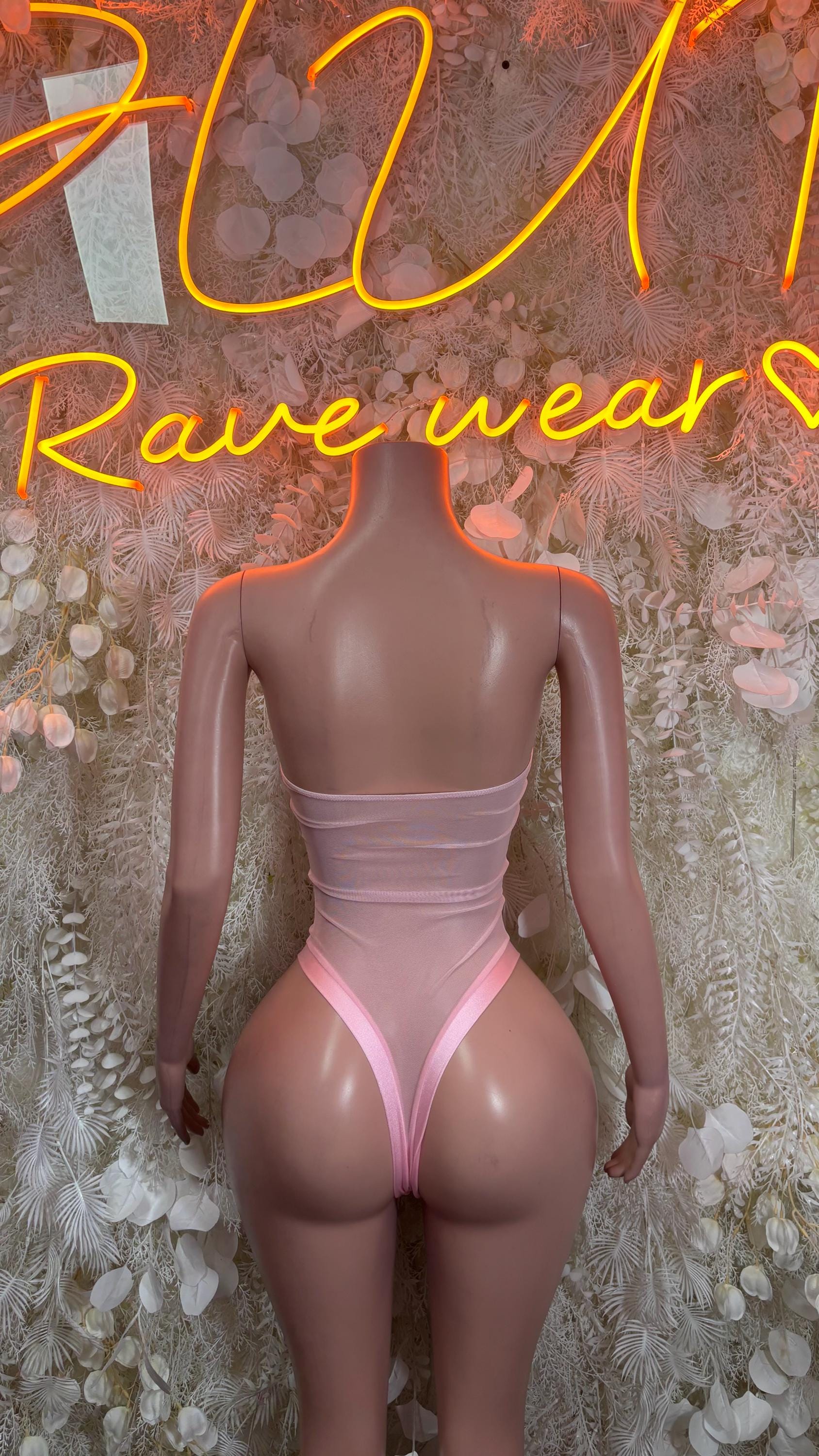 Pink baby bodysuit with lace-up back and ruched straps