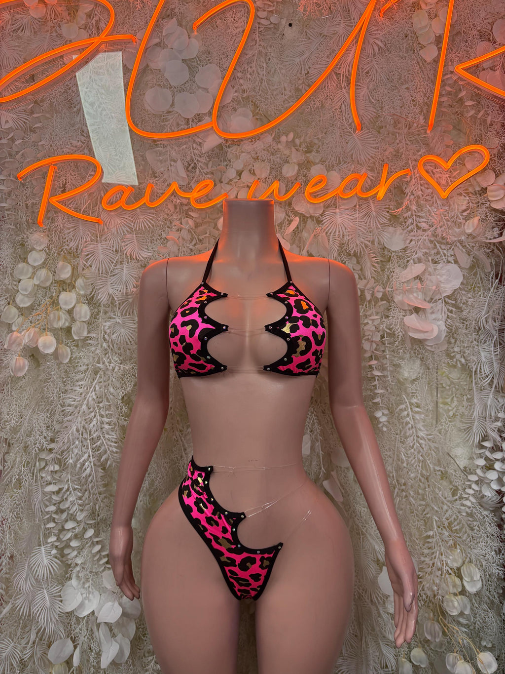 Pink leopard print two-piece rave set with black strappy triangle bra and matching bottoms