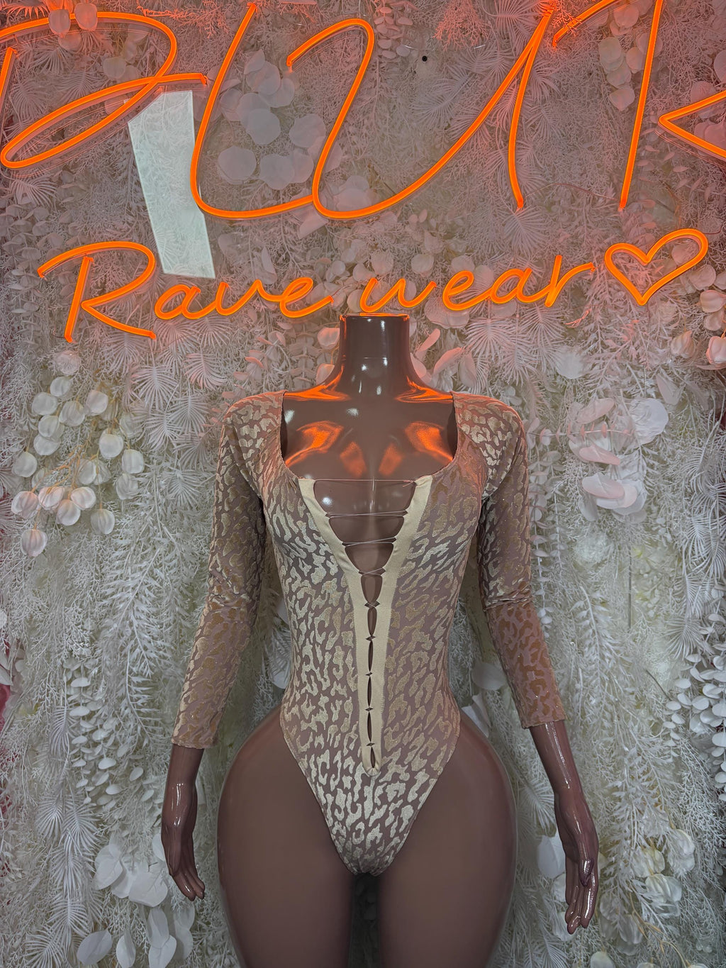 Tan long-sleeve snakeprint bodysuit with front zipper and deep V neckline
