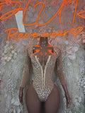 Tan long-sleeve snakeprint bodysuit with front zipper and deep V neckline
