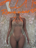 Tan one-piece bodysuit with deep oval cutout at chest and high-leg bottoms