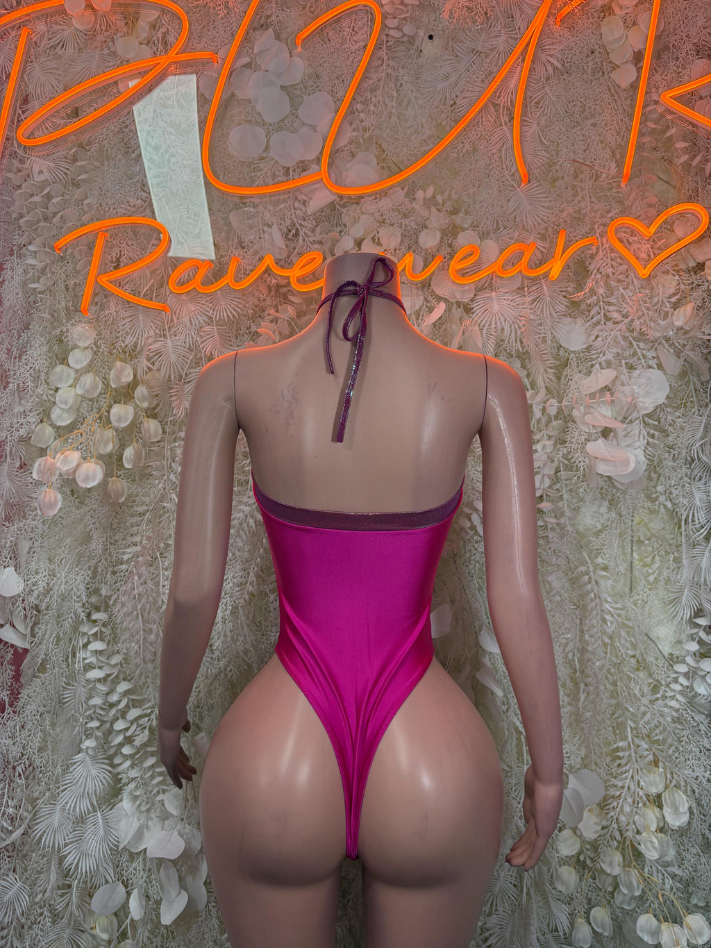 Pink halter rave bodysuit with crisscross tie at back