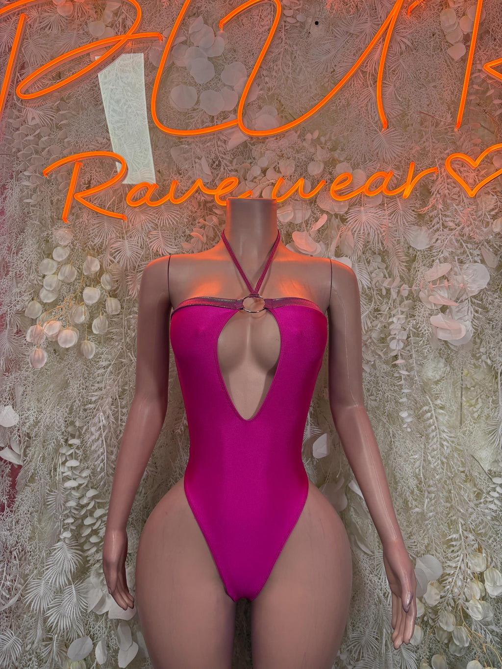 Pink halter-style rave bodysuit with keyhole cutout at back