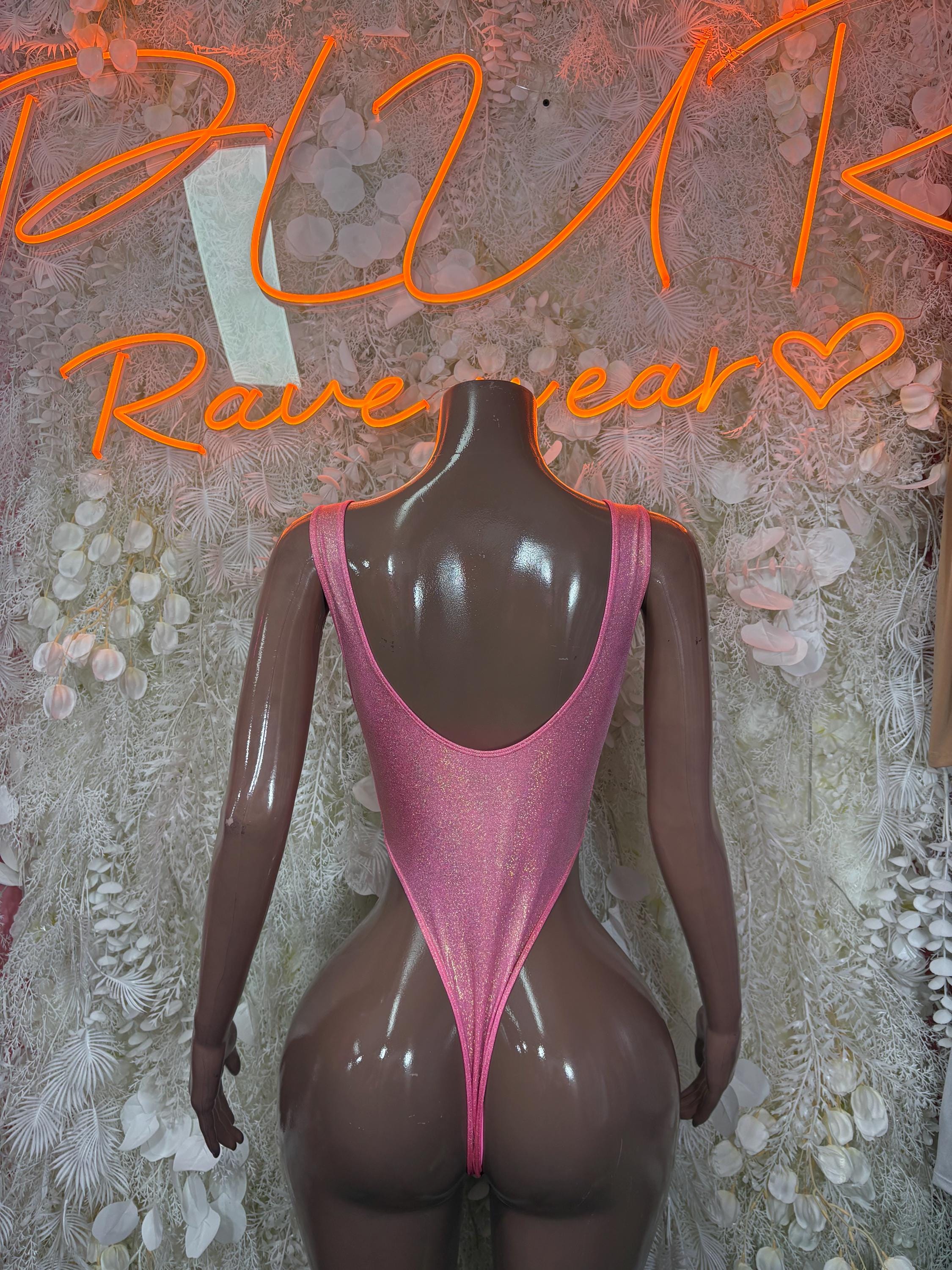 Pink glitter one-piece bodysuit with open-back cut and high-leg fit