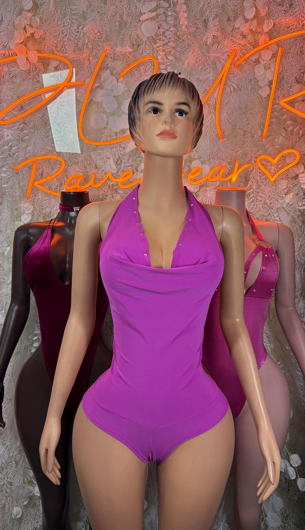 Purple halter bodysuit with cowl-like front neckline, sleeveless one-piece.