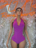 Purple halter bodysuit, draped neckline and one-piece fit.