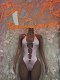 Pink halter lace-up bodysuit with crisscross front and high-cut legs