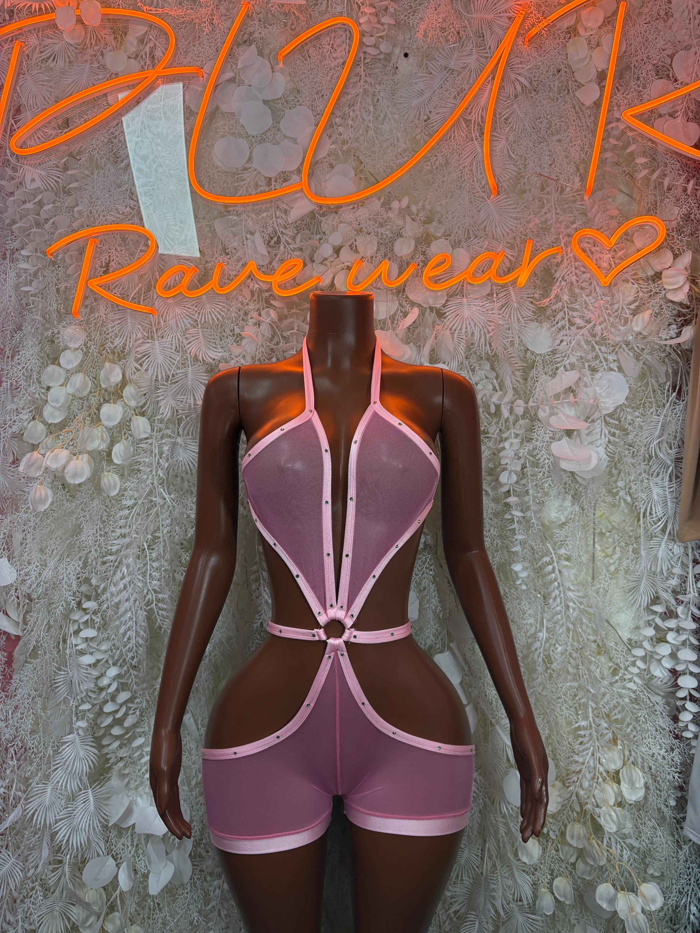 Pink lace-up bodysuit with open back and adjustable straps on a mannequin