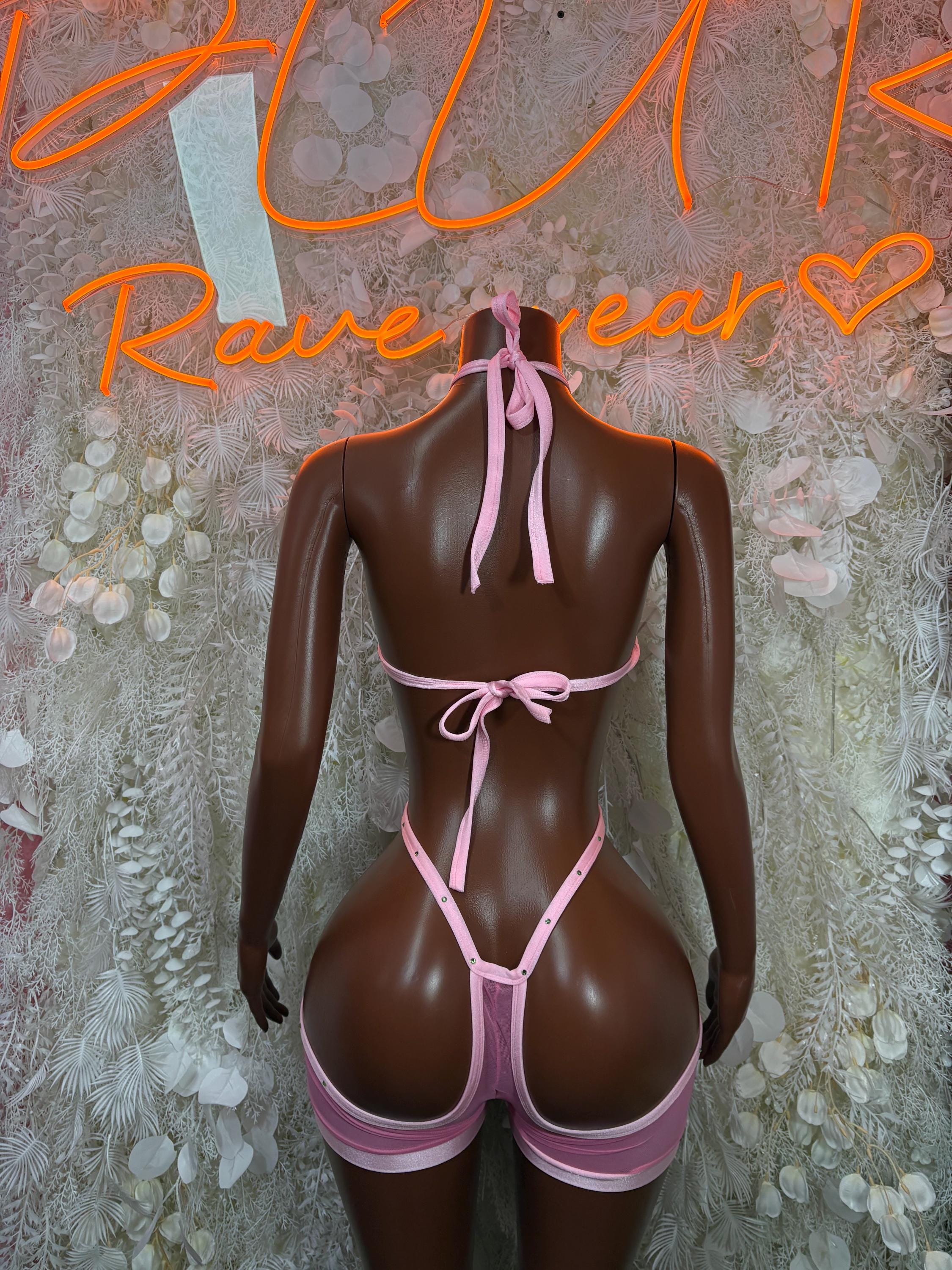 Pink open-back bodysuit with tie straps on a mannequin