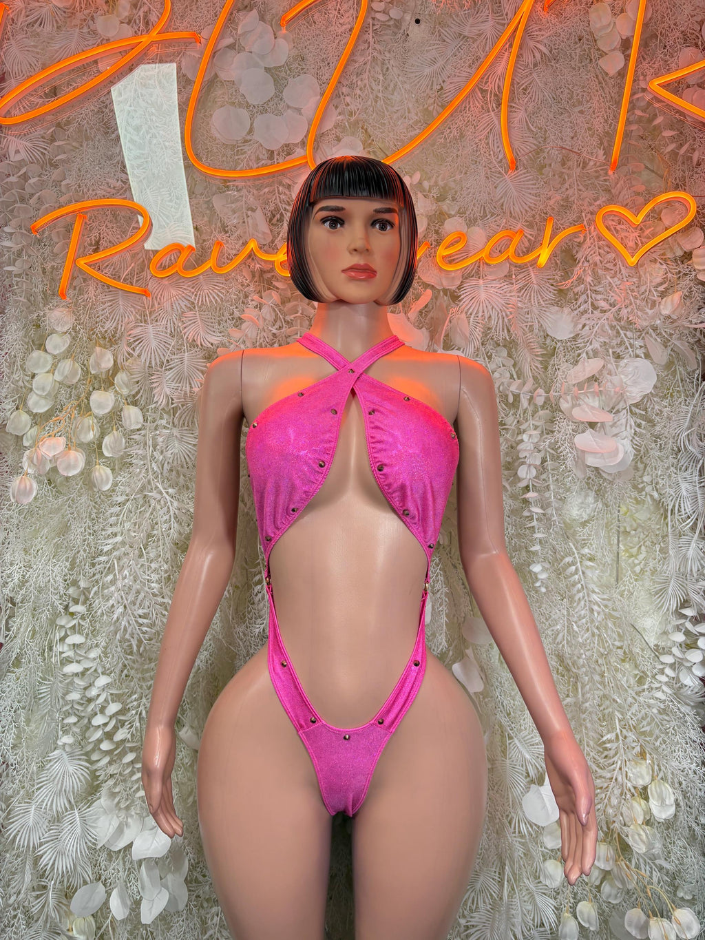 Pink glitter halter bodysuit with crisscross straps and thong back detail