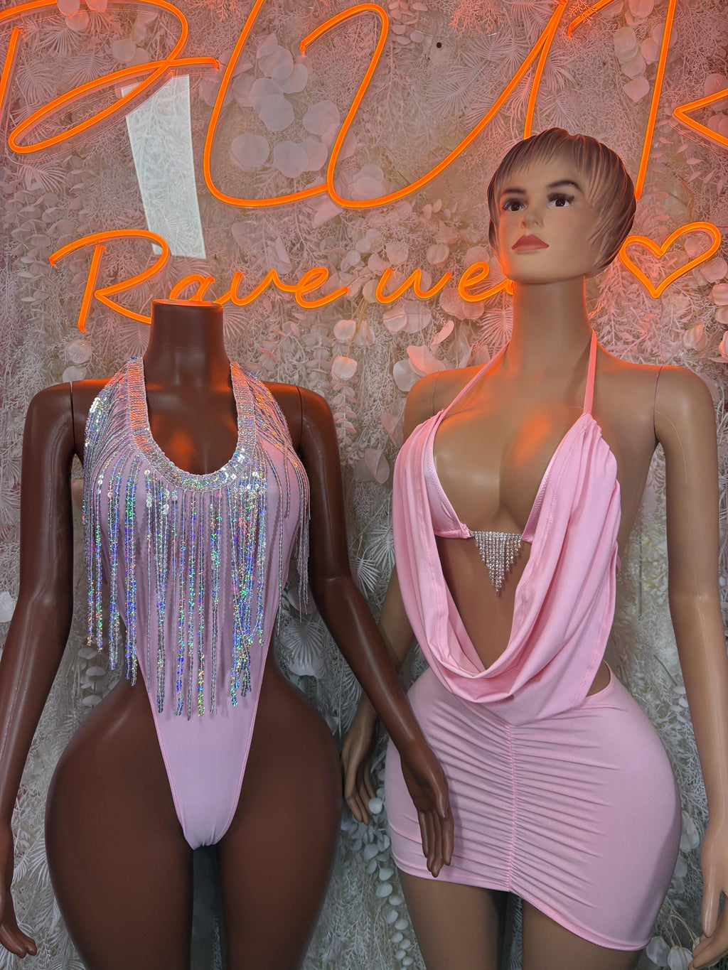 Baby pink ruched halter mini dress beside silver rhinestone one-piece swimsuit