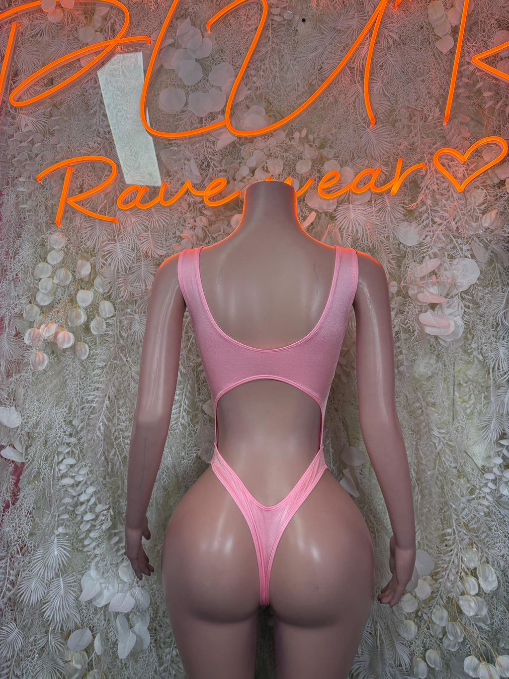 Pink sleeveless bodysuit with plunging front cutout and high-leg thong bottom