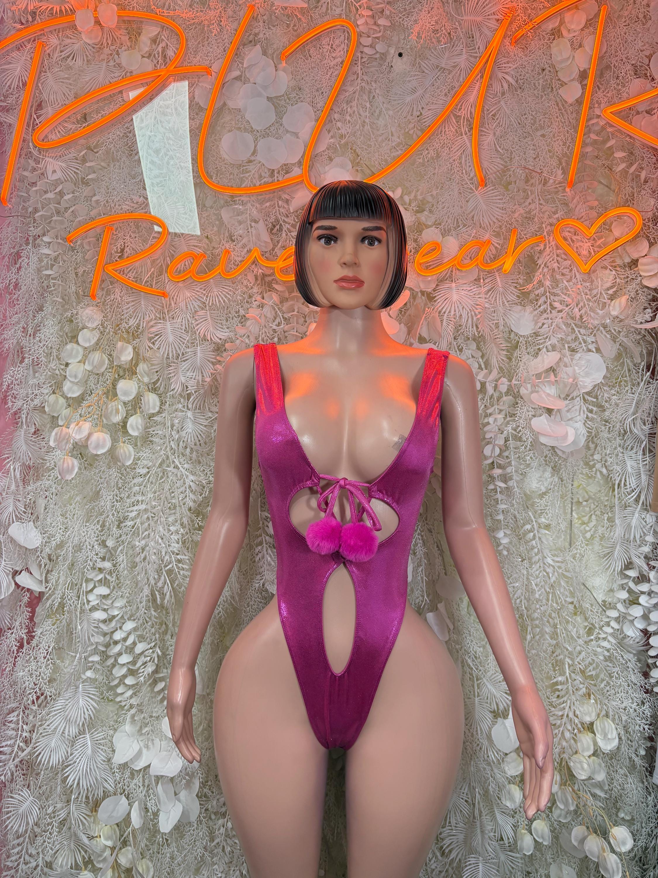 Purple festival bodysuit with deep V neckline, front keyhole cutout, and pink bow detail