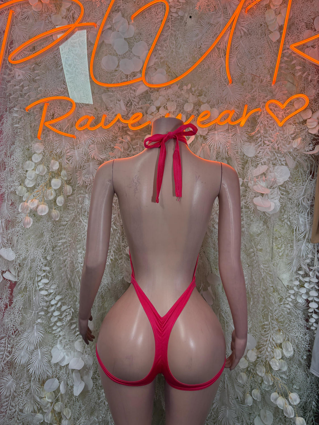Pink backless bodysuit with tie halter straps and open back V-shape