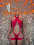 Pink halter bodysuit with twisted front cutout and high-leg bottoms