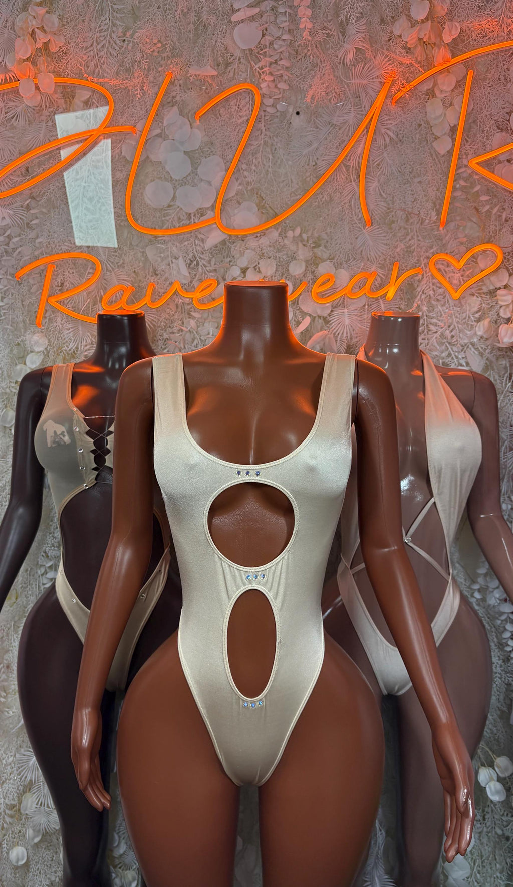 Cream cutout one-piece bodysuit shown on two mannequins, scoop front