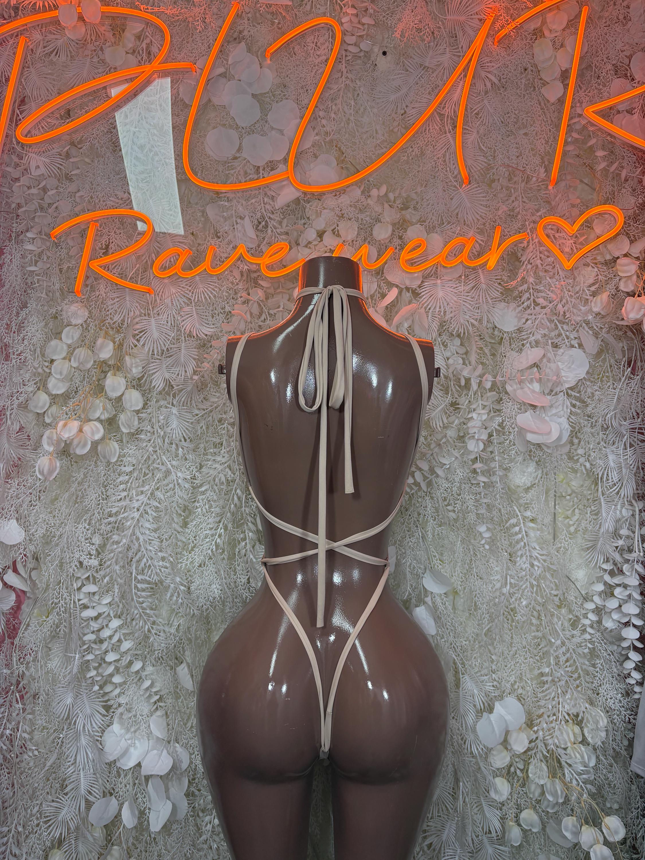 Nude backless bodysuit with tie halter straps and high-cut legs