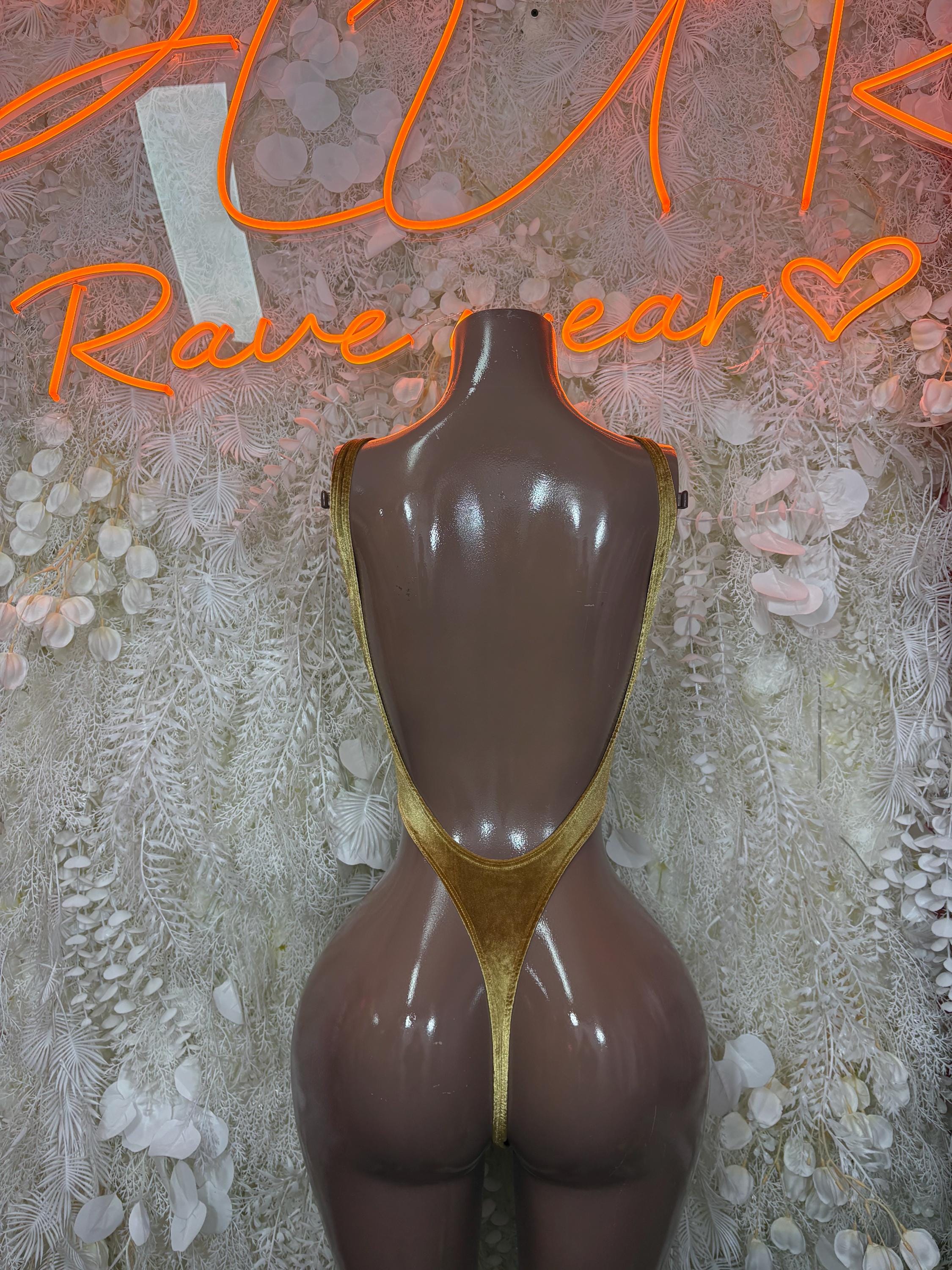 Gold metallic bodysuit with scoop back and high leg cut on mannequin
