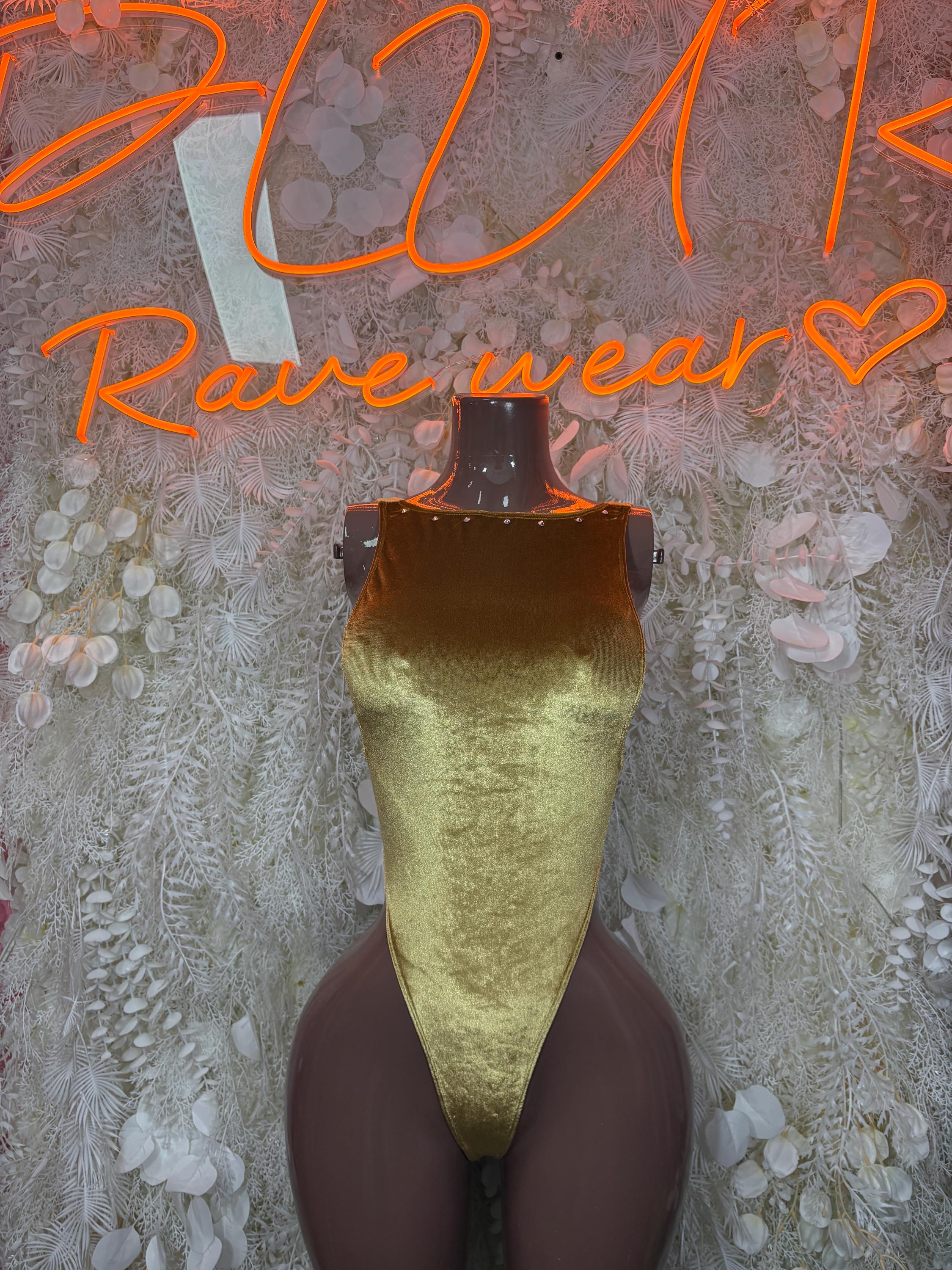 Gold metallic high-cut bodysuit, V-back and deep hip opening on mannequin