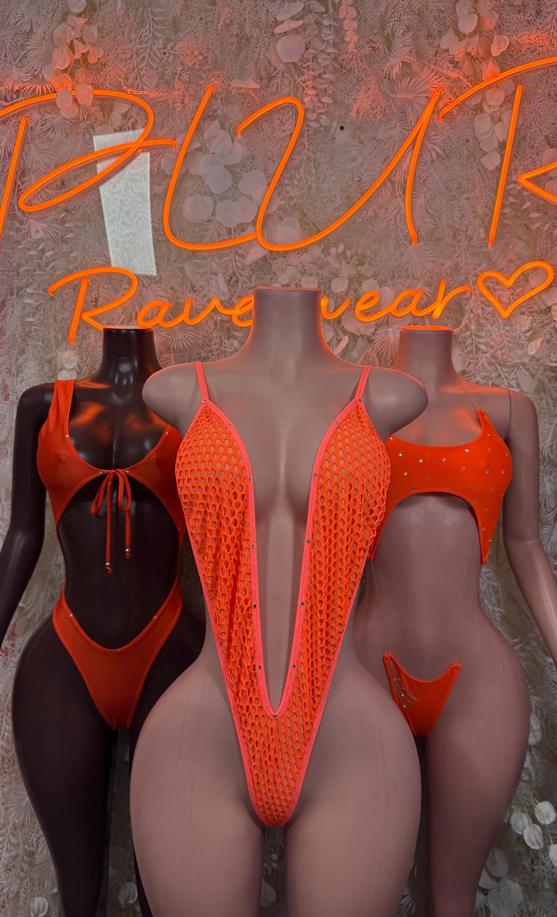 Neon orange mesh one-piece bodysuit with deep V front, displayed with black bodysuits