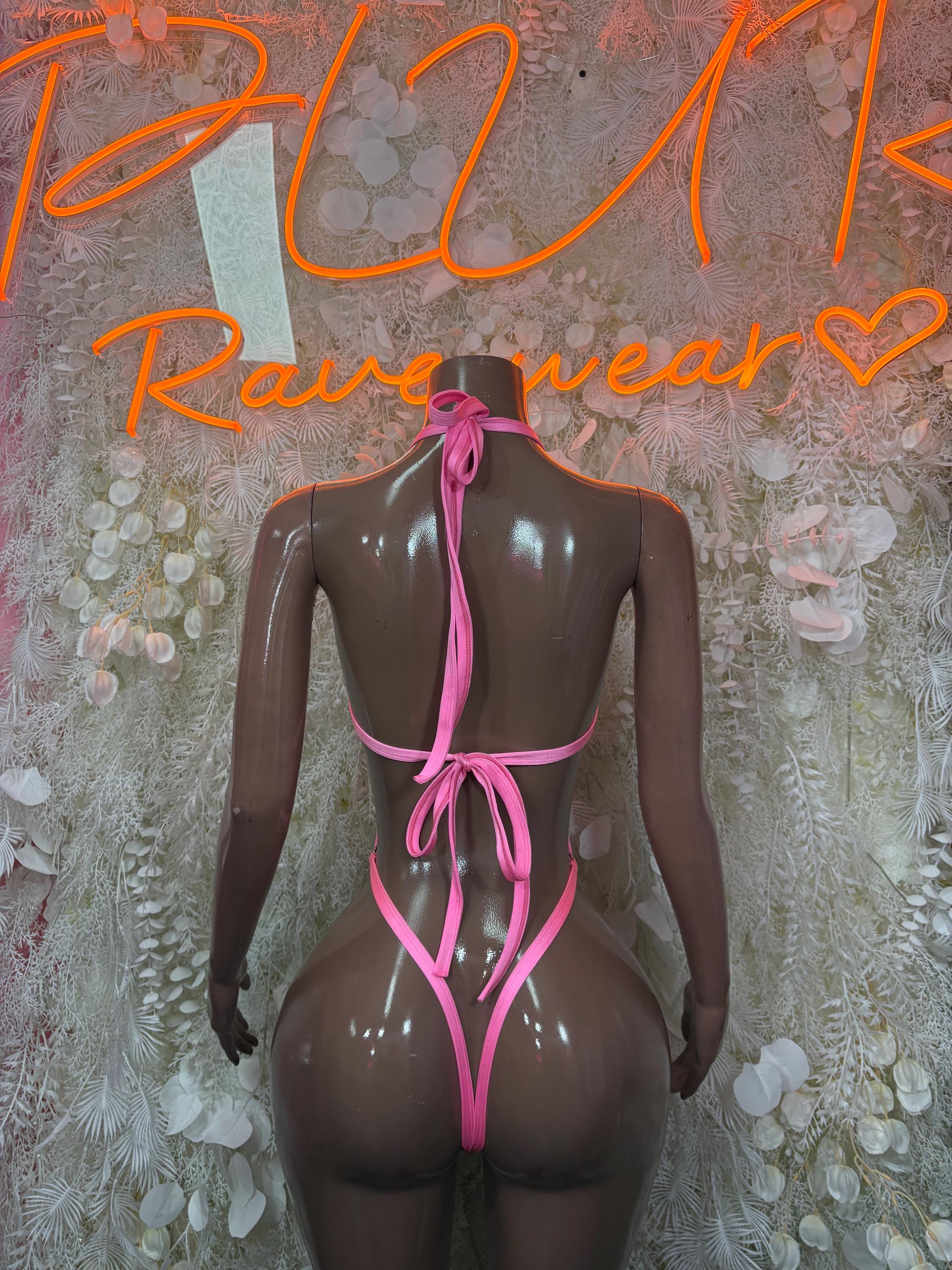 Pink halter one-piece bodysuit with back tie straps and high-cut legs