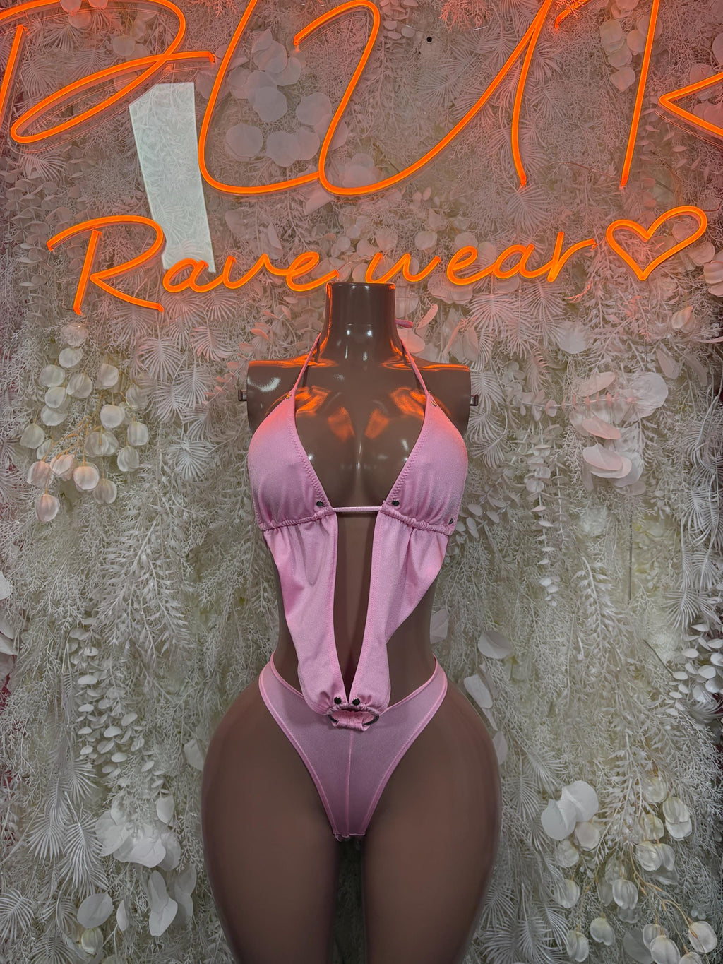 Pink one-piece bodysuit with halter ties and deep V front, lace-up center