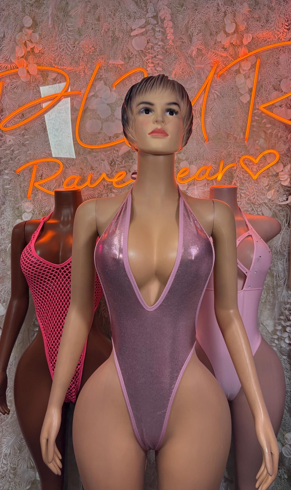 Pink one-piece bodysuit with halter neckline, front view