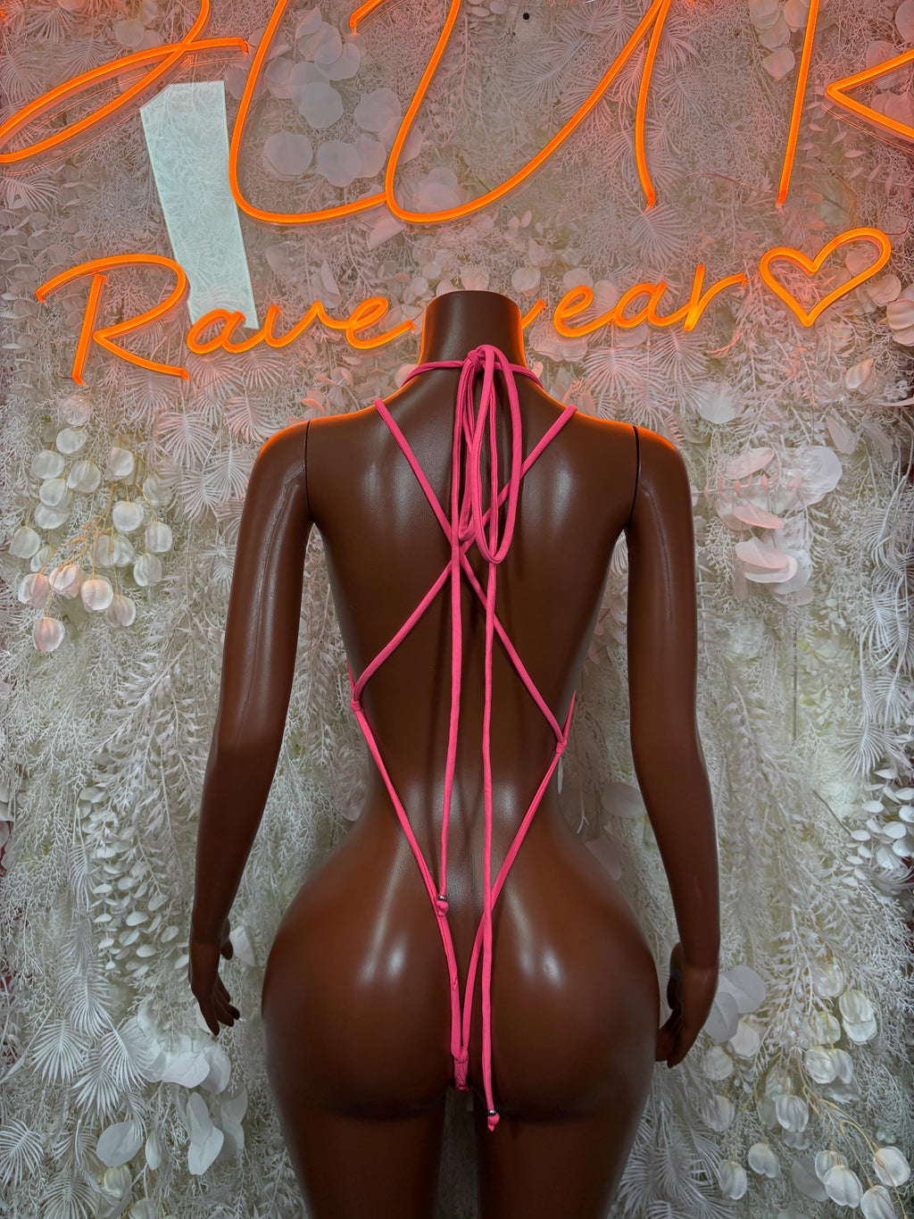 Pink fishnet bodysuit back view with crisscross tie straps