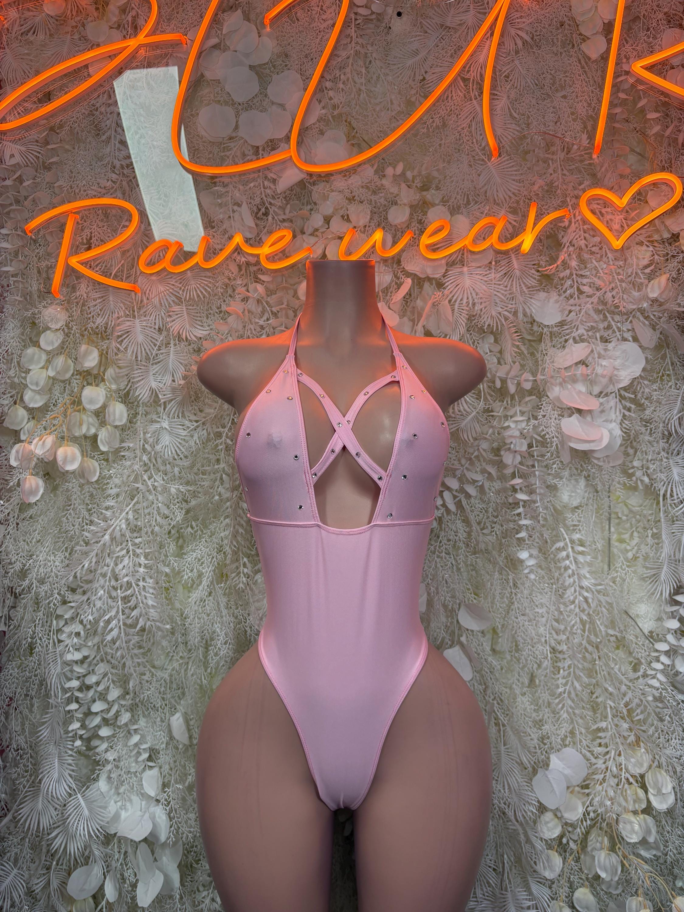 Pink one-piece bodysuit with crisscross open back and high-cut legs