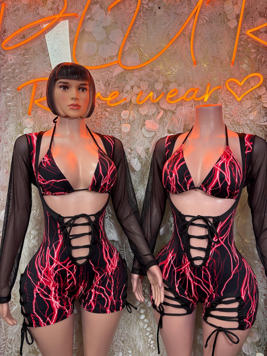 Pair of black sheer long-sleeve bodysuits with red electric print and lace-up fronts