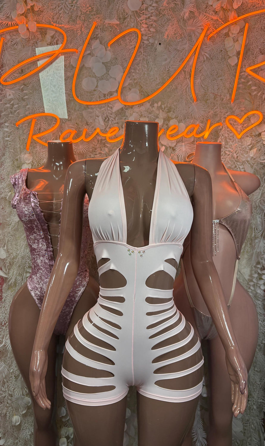 Pink halter cutoff bodysuit front view with deep chest cutout and rib panels