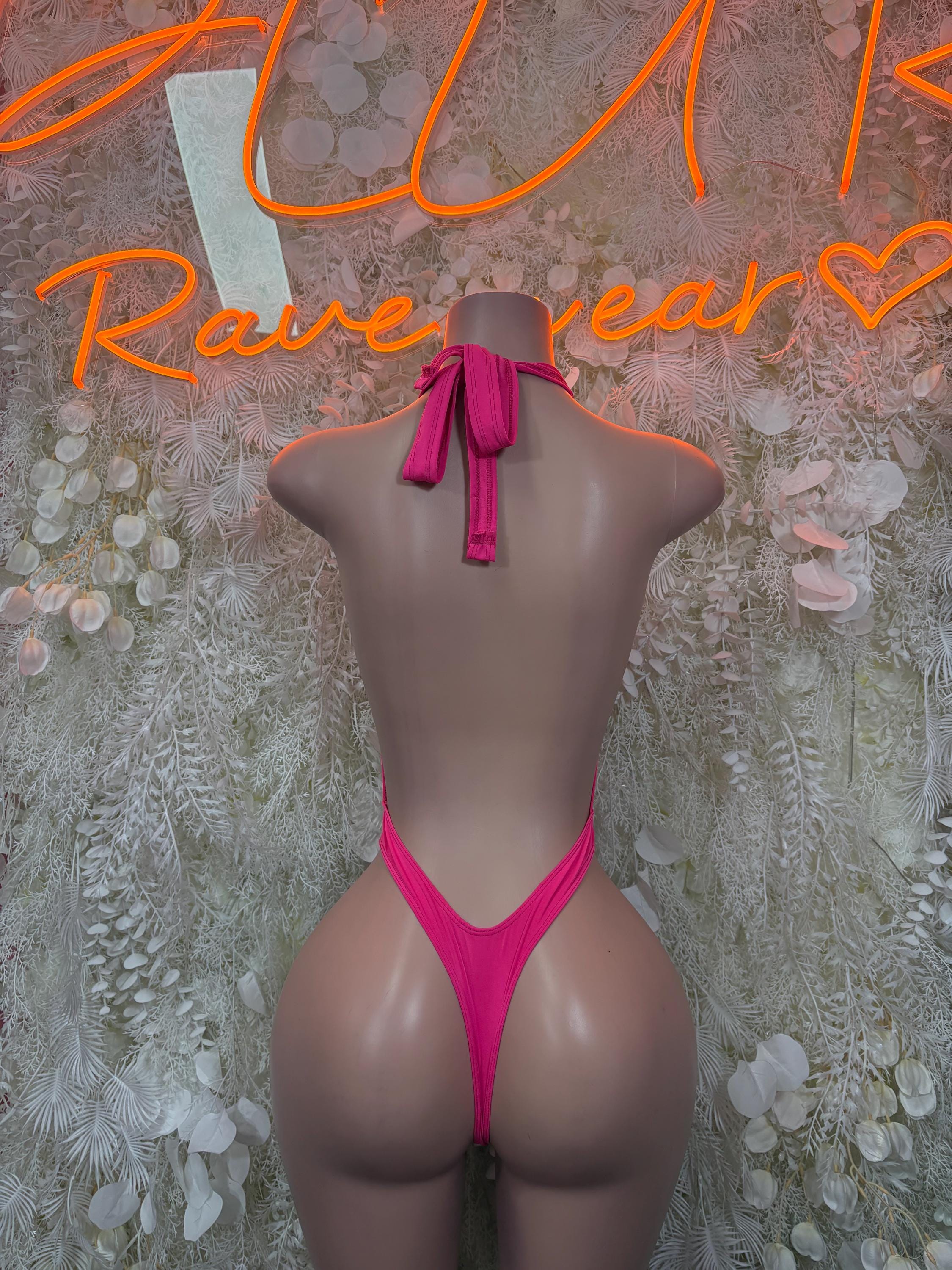 Pink one-piece bodysuit with strappy V-back and tied bow at neck