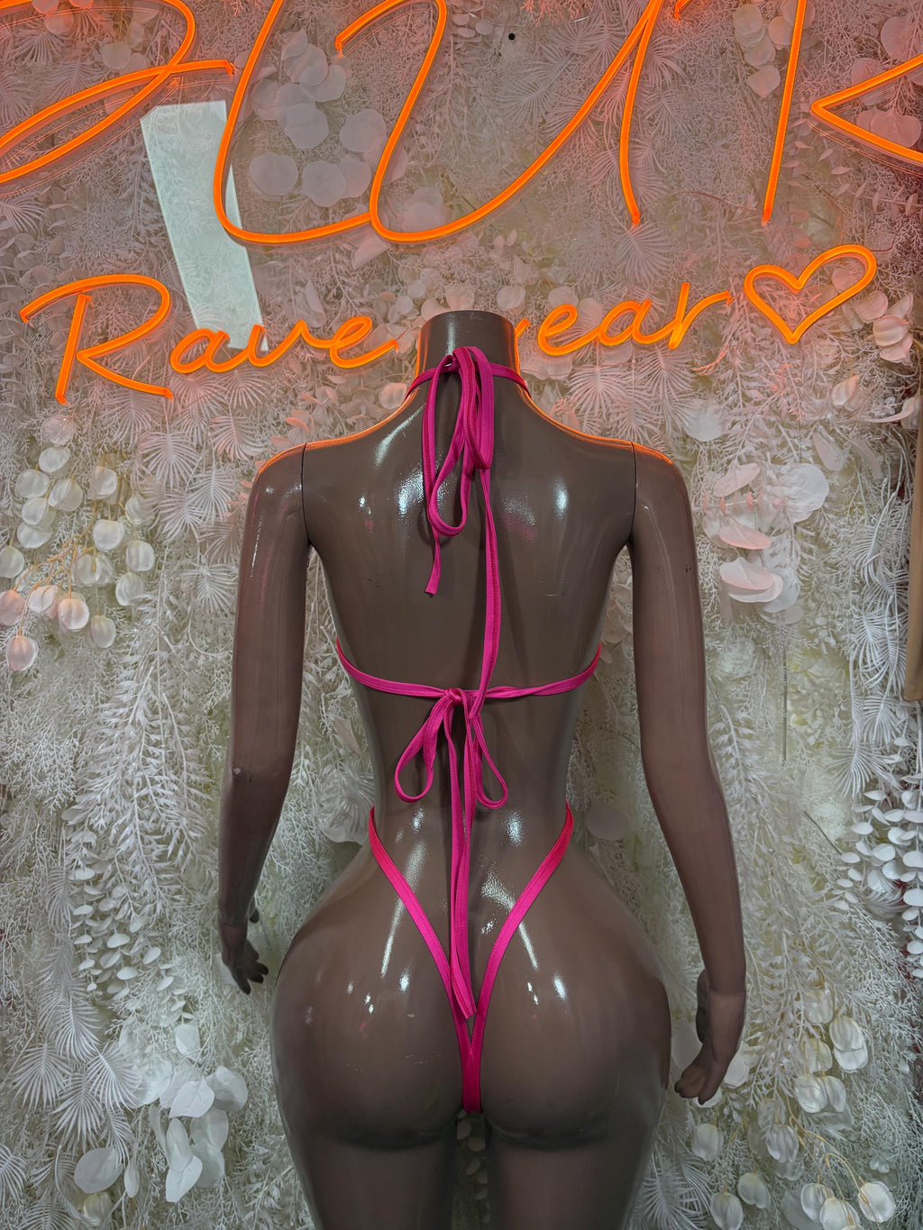 Pink metallic one-piece bodysuit with crisscross lace-up open back and thong straps
