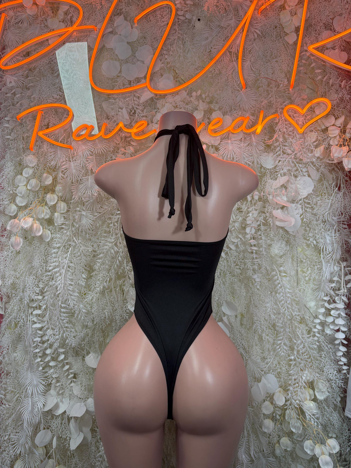 Black one-piece halter bodysuit with low back and tie straps