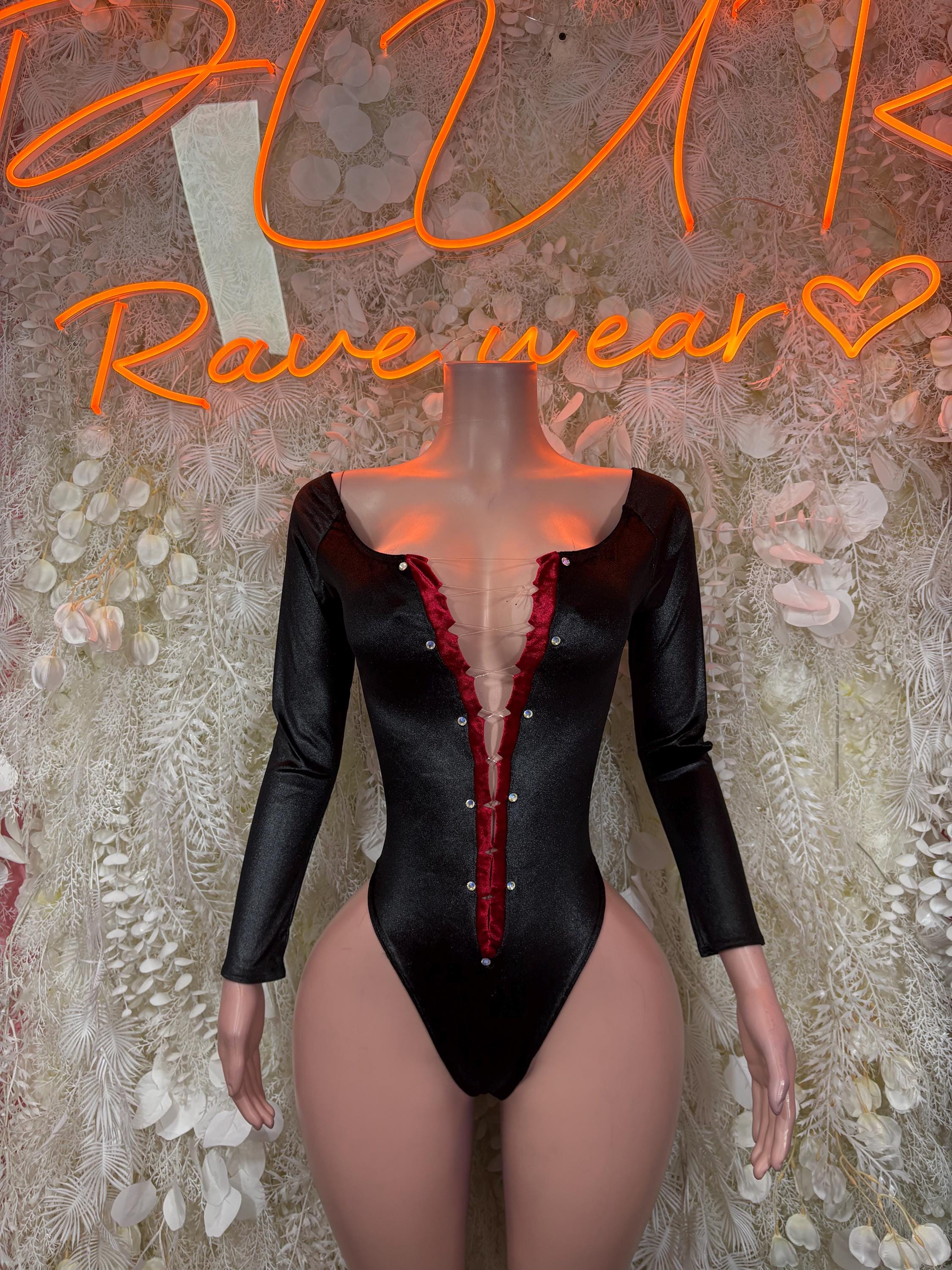 Black long-sleeve bodysuit with deep V neckline and red center trim