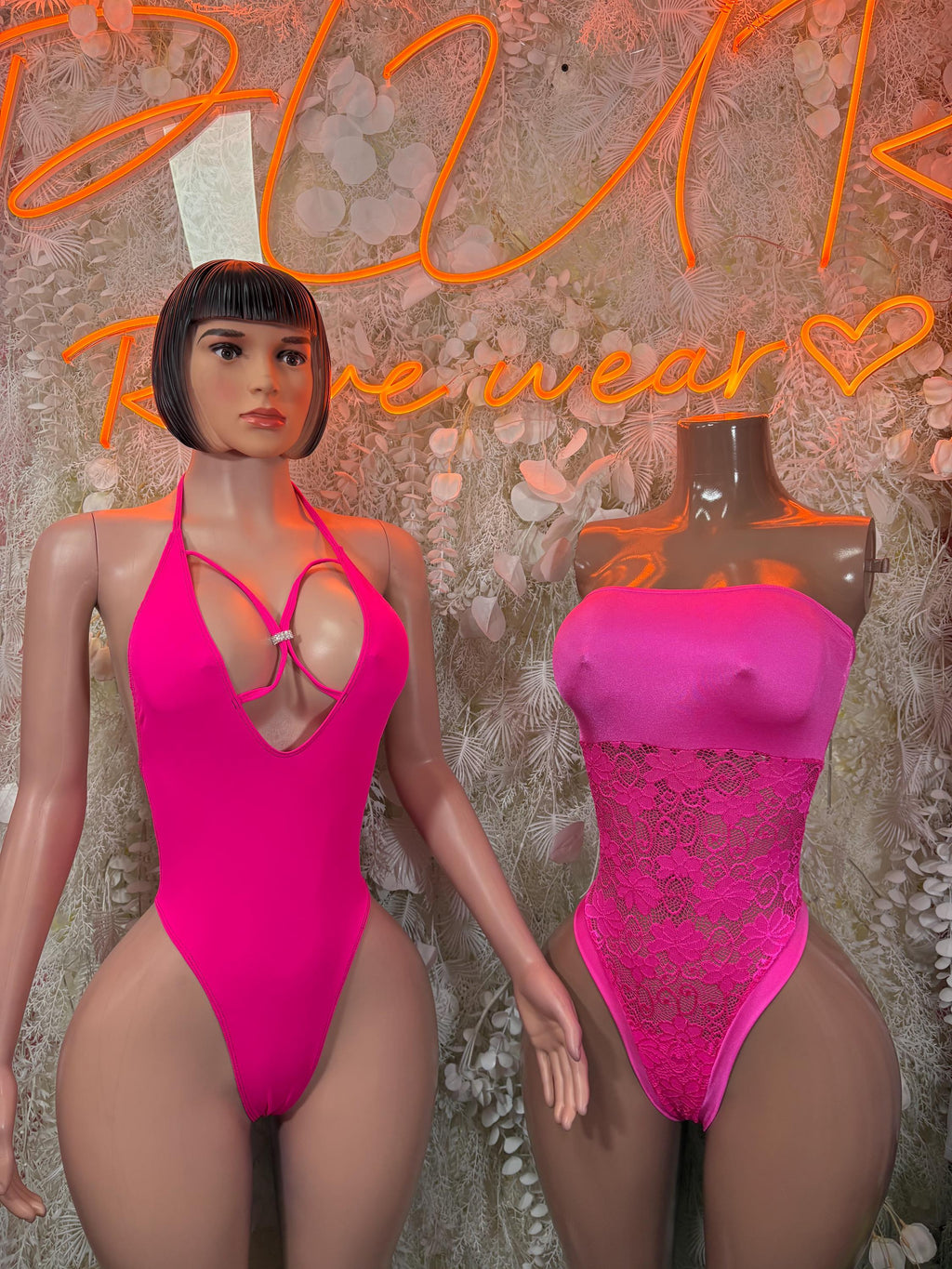 Hot pink lace bodysuit with strappy cutout chest and high-leg fit